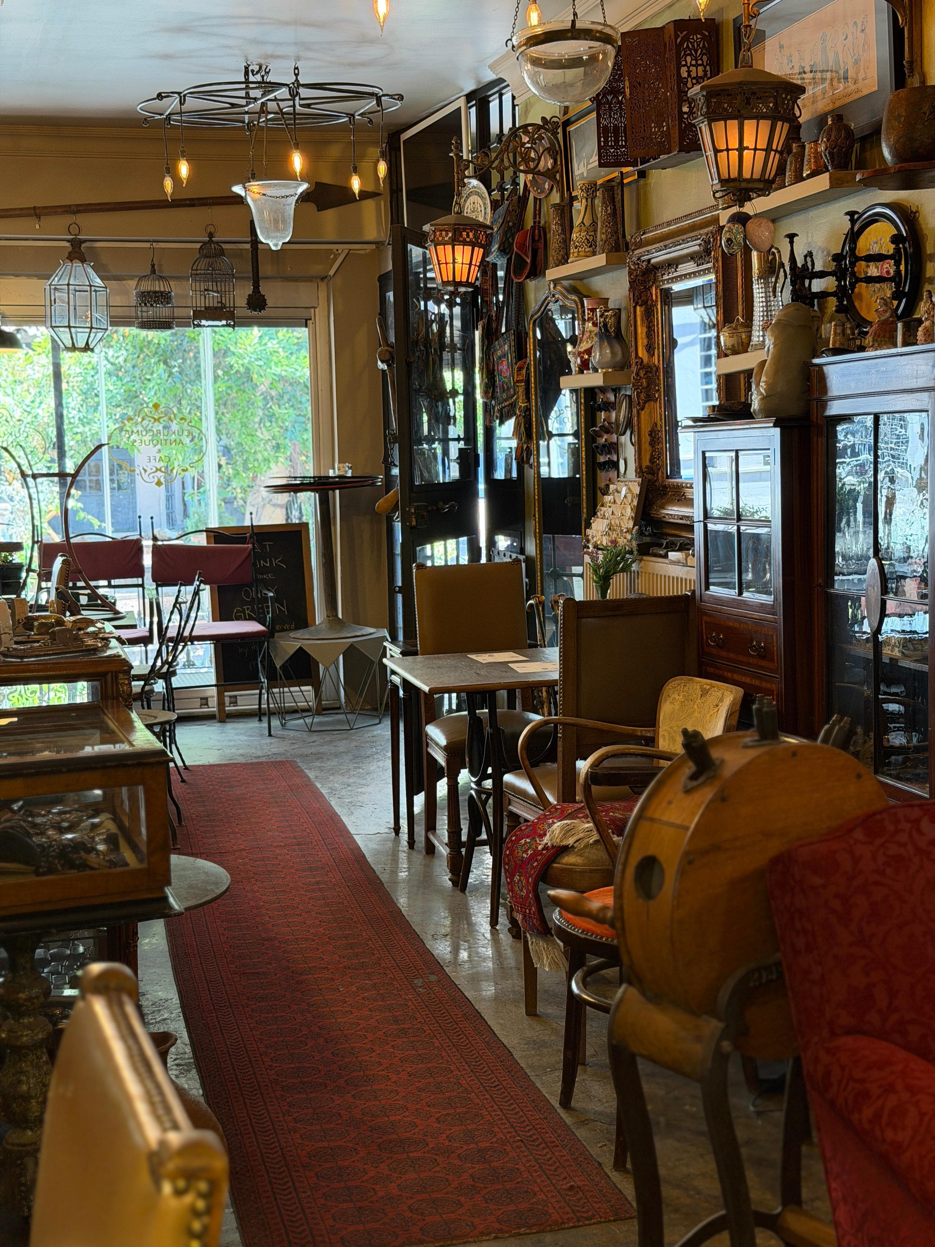 Looking out to the street through the antique-filled room