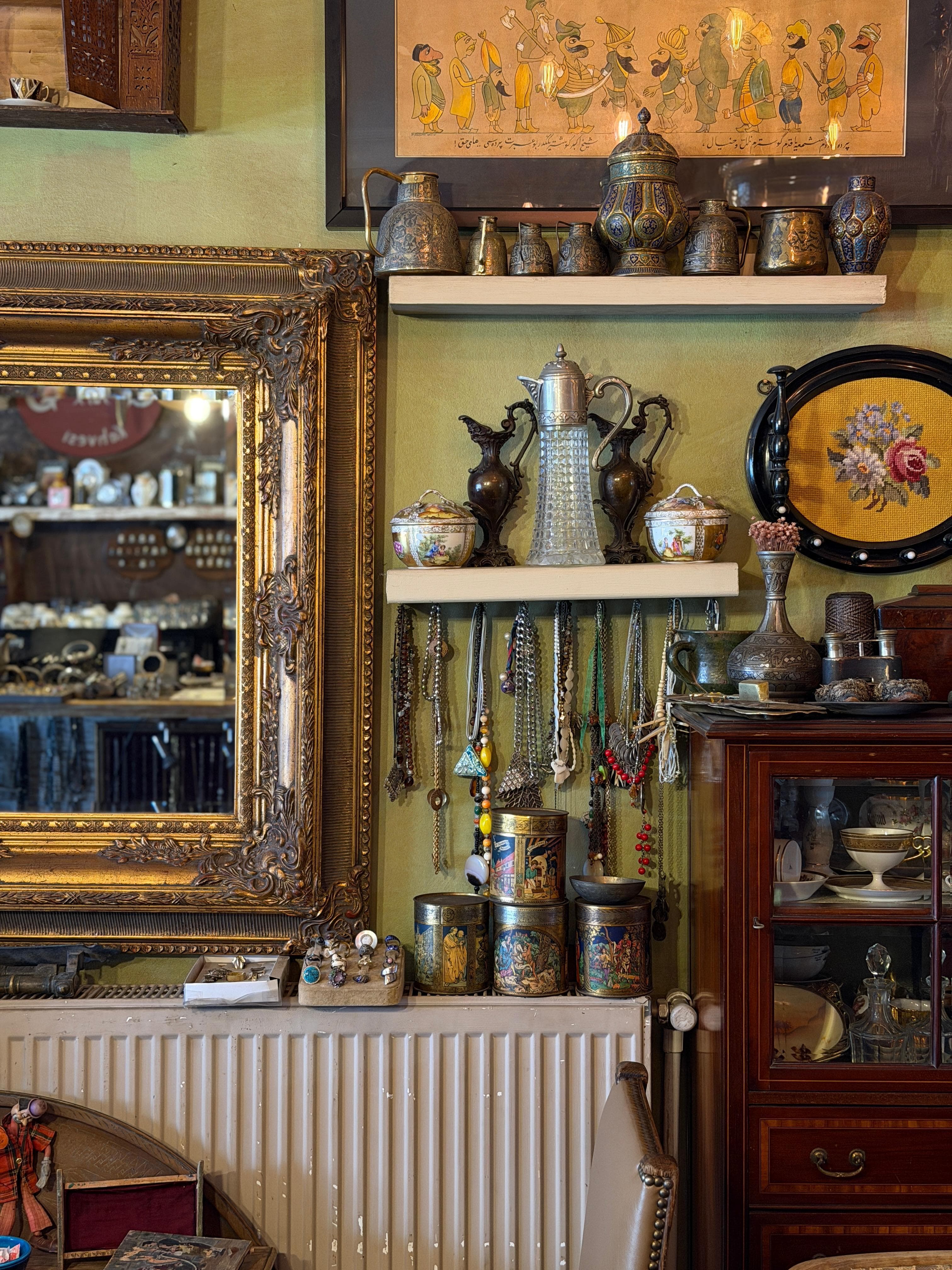 Shelves of silver ewers and gilded mirrors